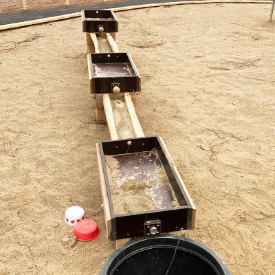 Water troughs for playgrounds lined up in a row.